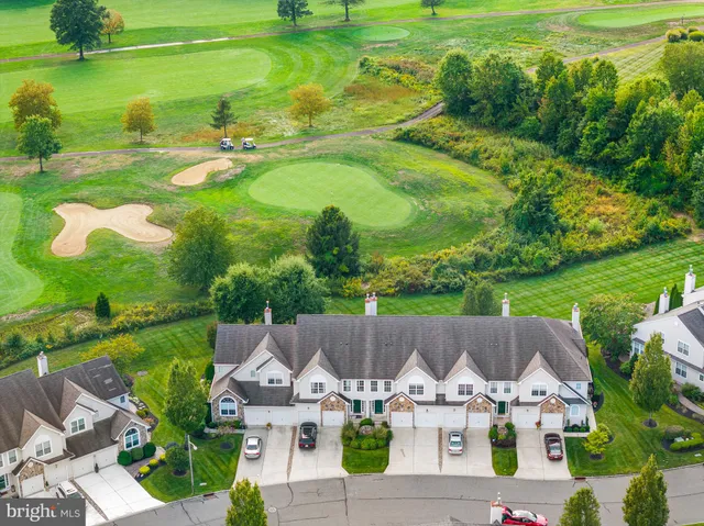 an aerial view of a house with garden space and lake view