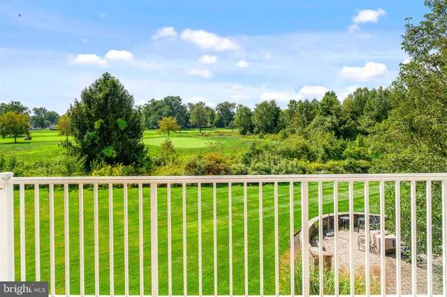 a view of a yard with wooden fence