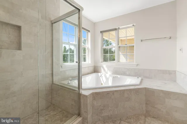 a bath tub sitting in a bathroom next to a window