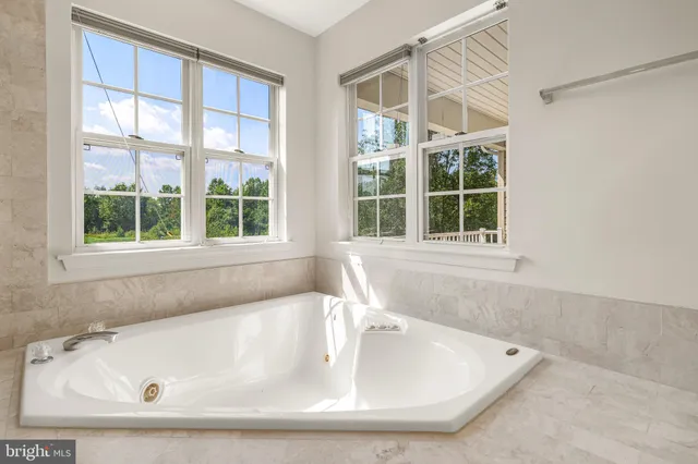 a bath tub sitting next to a window