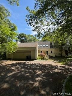 1117 Cedar Ridge Road Oyster Bay, NY 11771 - Photo 40 of 41 a front view of a house with a yard and garage