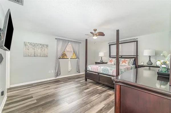 a bedroom with furniture and mirror