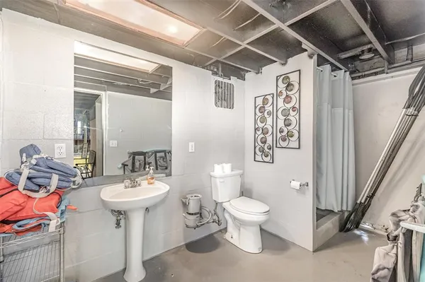 a bathroom with a toilet sink and mirror