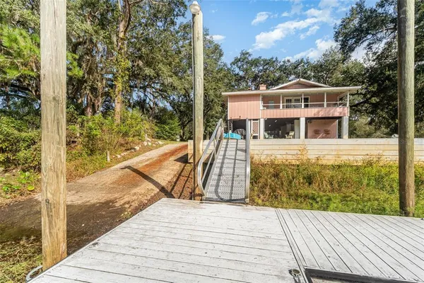 a view of a balcony with wooden floor and fence
