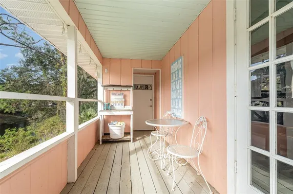 a view of balcony with wooden floor and seating space