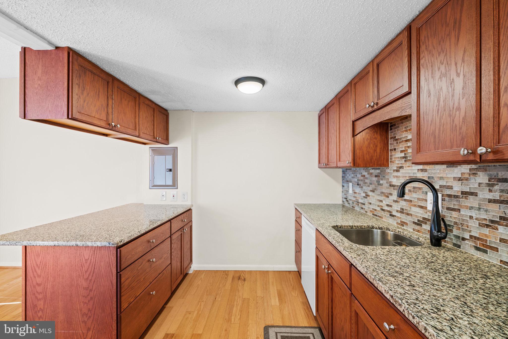 11807 Breton Court, Unit 1A Reston, VA 20191 - Photo 5 of 19 Granite countertops and soft close cabinets