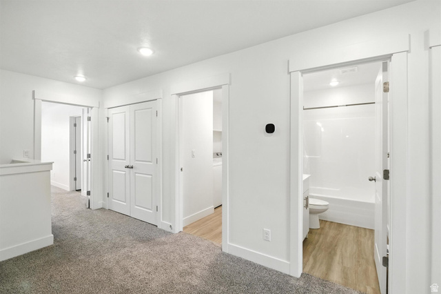 1221 West 1870 South Logan, UT 84321 - Photo 7 of 20 Open hallway featuring plush carpet flooring, recessed lighting, white trim, and white paneled doors