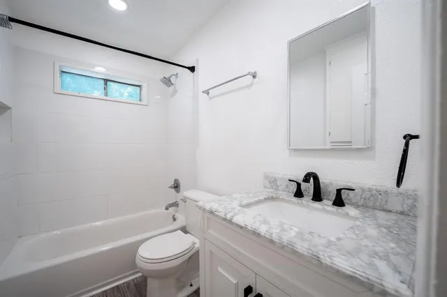 a bathroom with a sink a toilet and a tub
