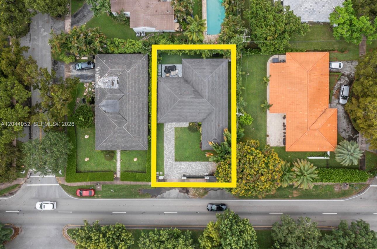 721 Bird Road Coral Gables, FL 33146 - Photo 24 of 24 an aerial view of a house with a yard and table and chairs