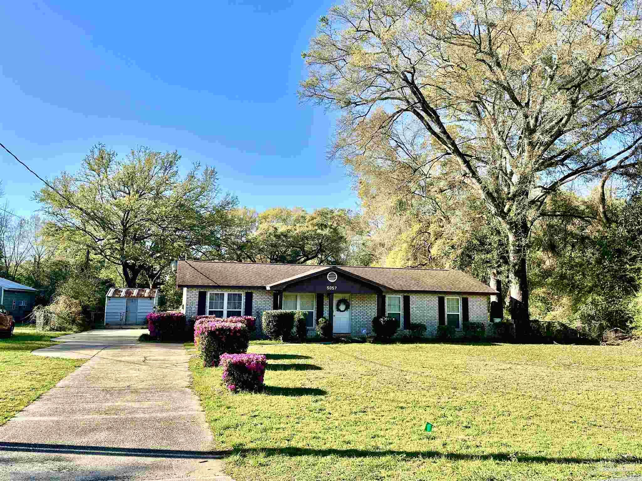5057 Babb Lane Pace, FL 32571 - Photo 1 of 33 a front view of a house with a yard