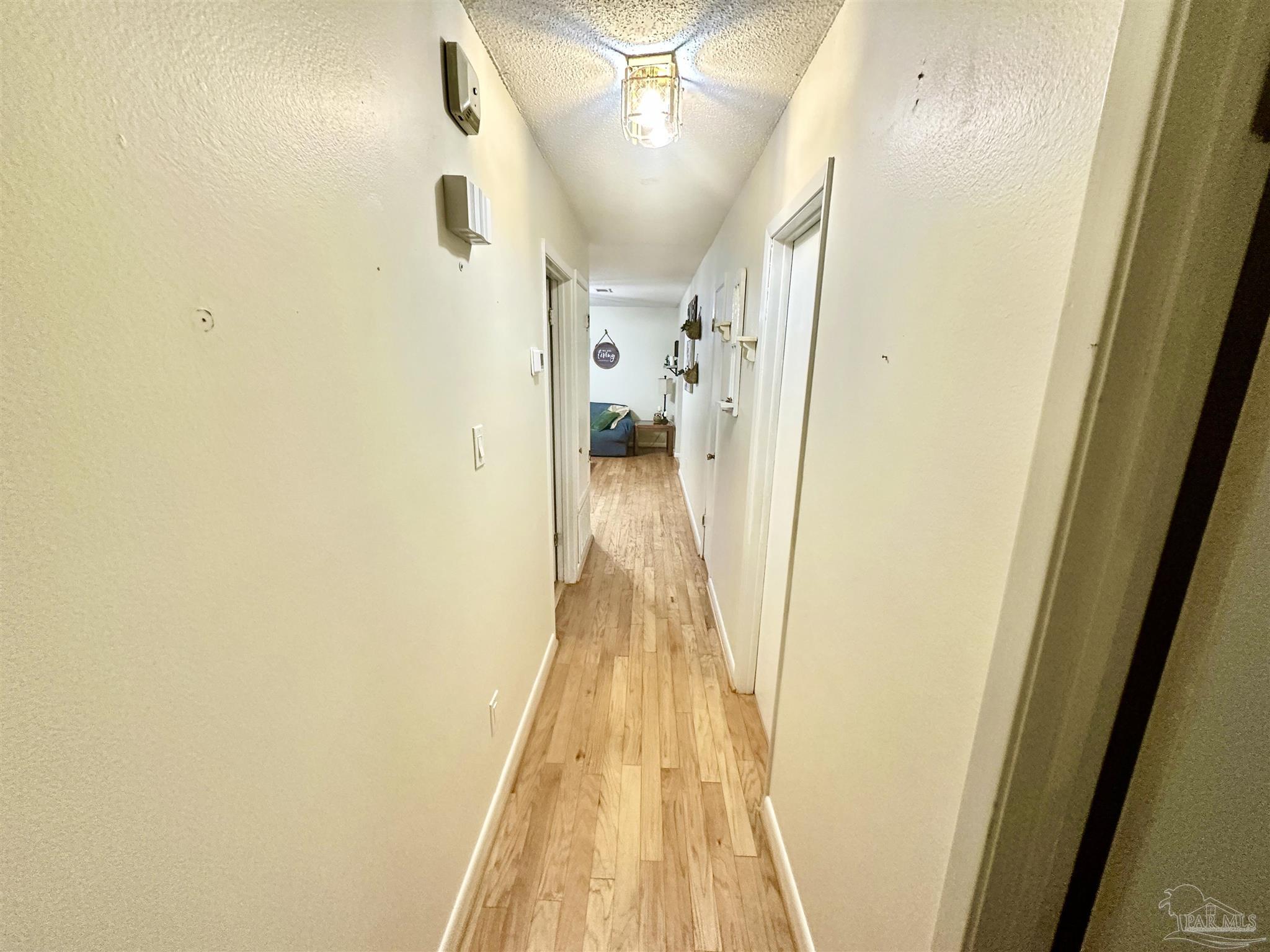 5057 Babb Lane Pace, FL 32571 - Photo 11 of 33 a view of a hallway with wooden floor and staircase