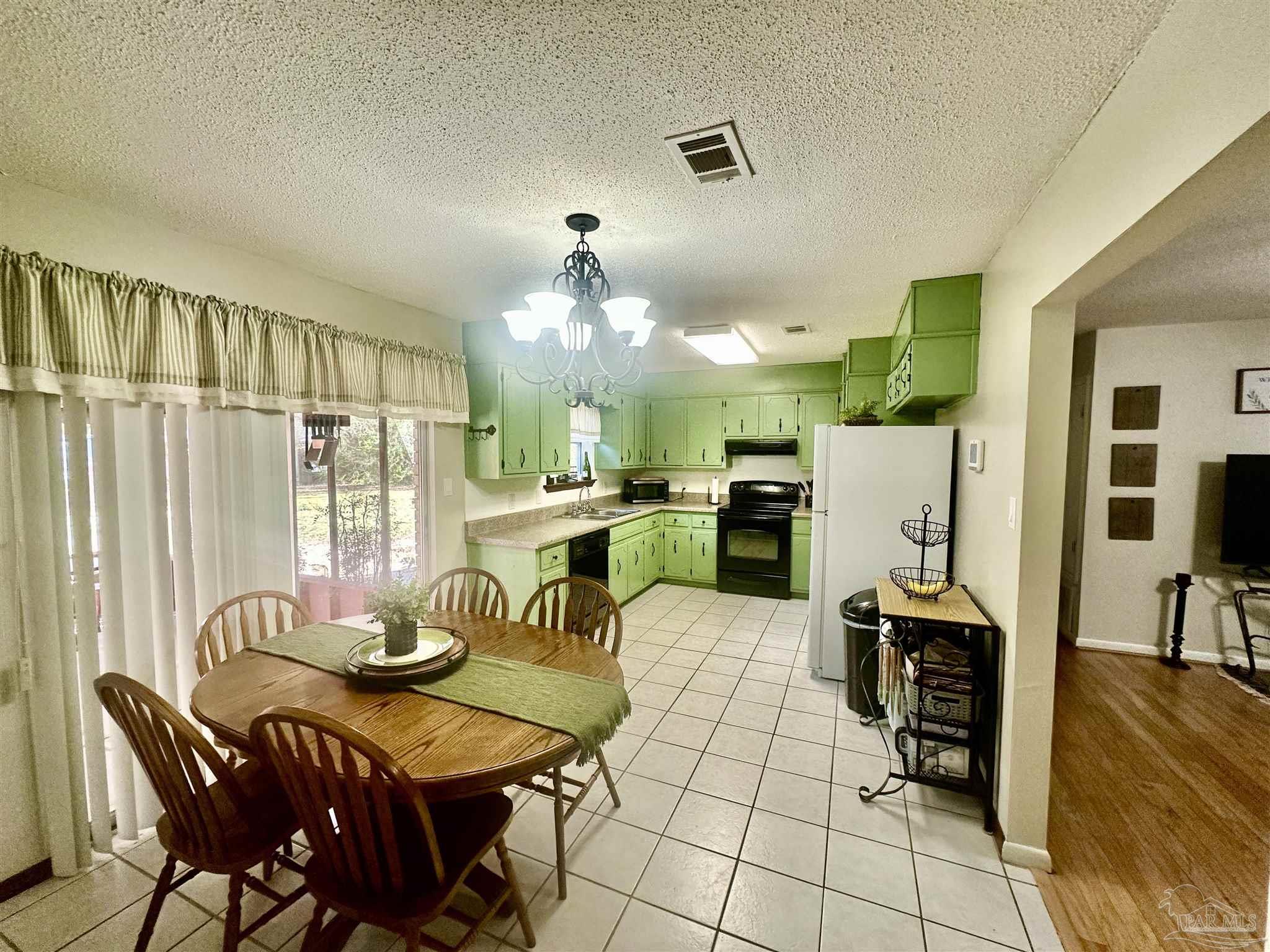 5057 Babb Lane Pace, FL 32571 - Photo 13 of 33 a view of a dining room with furniture and chandelier