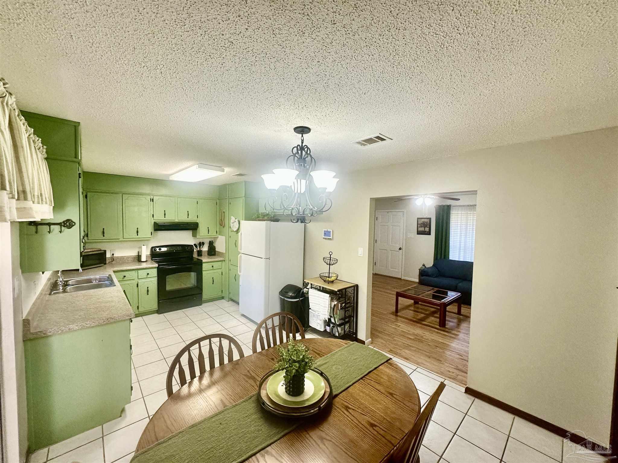 5057 Babb Lane Pace, FL 32571 - Photo 14 of 33 a living room with furniture and a chandelier