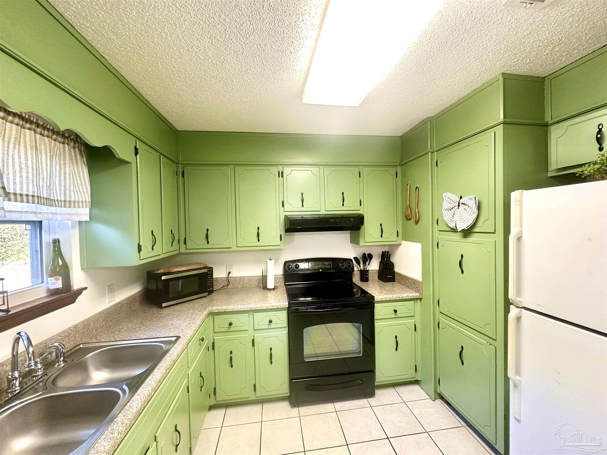5057 Babb Lane Pace, FL 32571 - Photo 15 of 33 a kitchen with a refrigerator and a sink