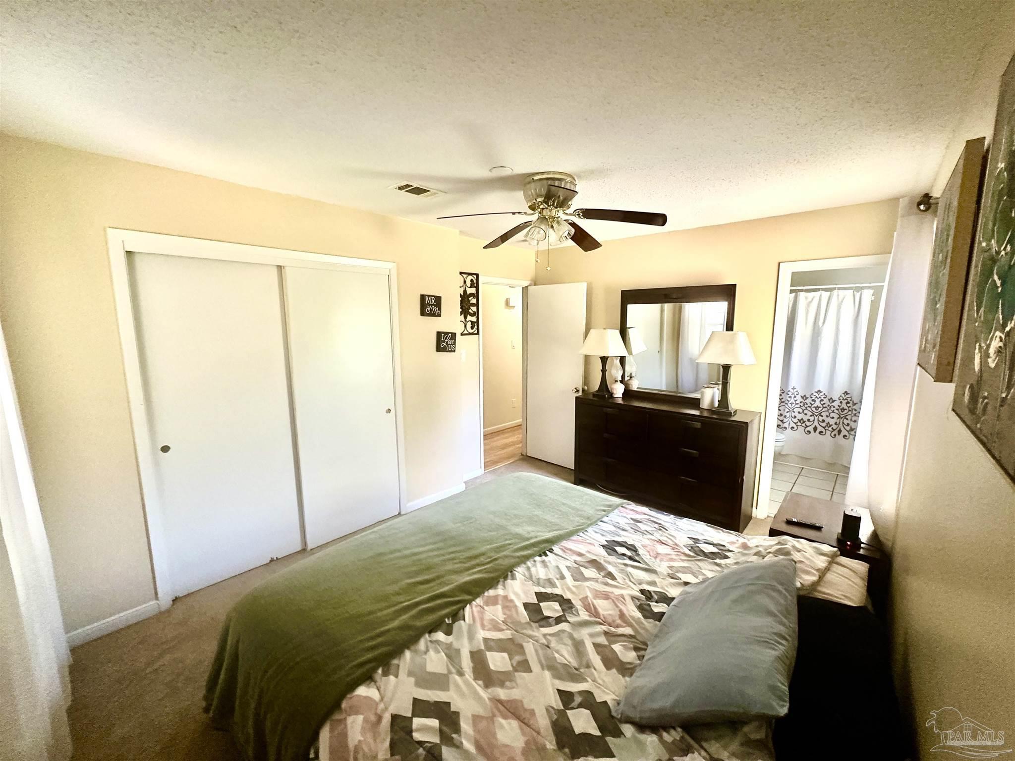 5057 Babb Lane Pace, FL 32571 - Photo 17 of 33 a bedroom with a bed and a mirror