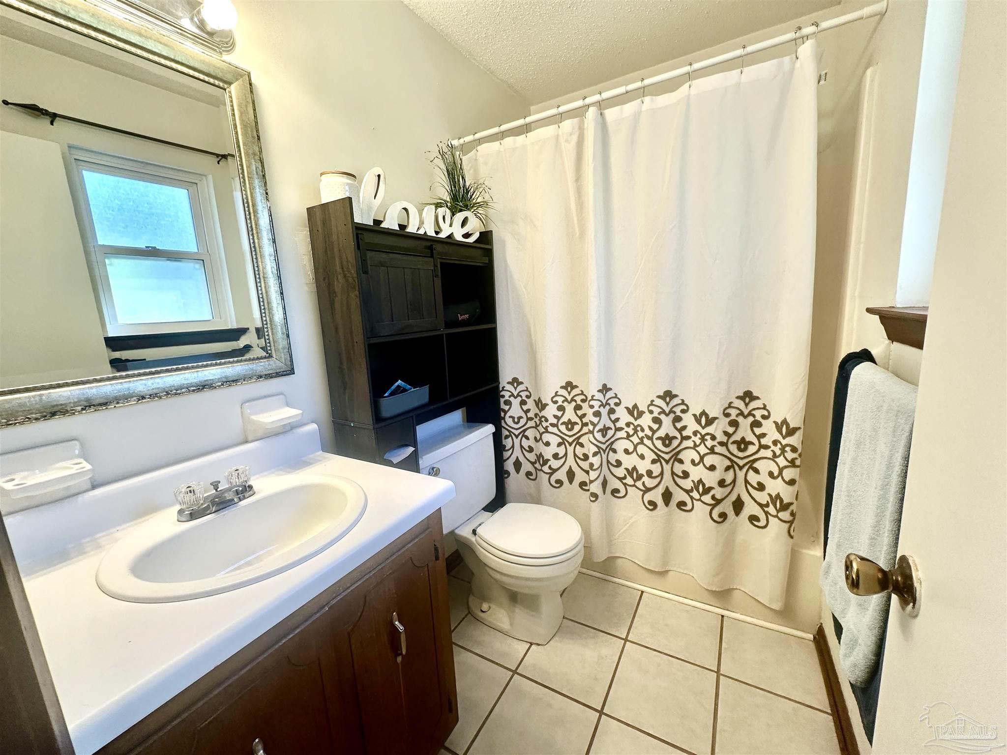 5057 Babb Lane Pace, FL 32571 - Photo 19 of 33 a bathroom with a sink toilet and shower