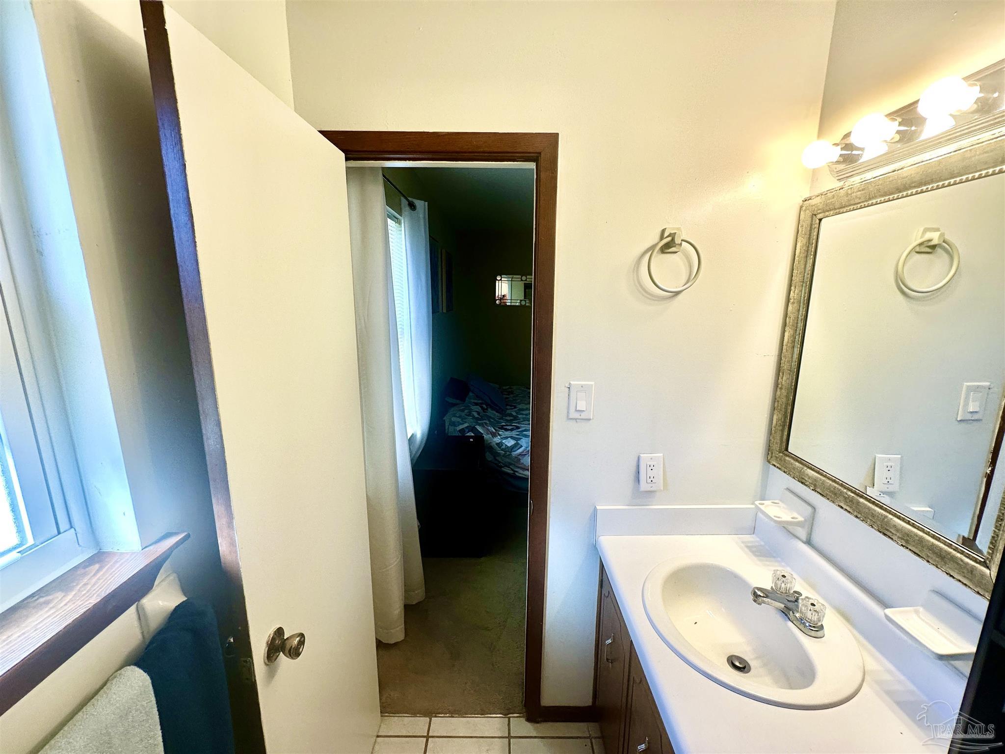 5057 Babb Lane Pace, FL 32571 - Photo 20 of 33 a bathroom with a sink and a mirror