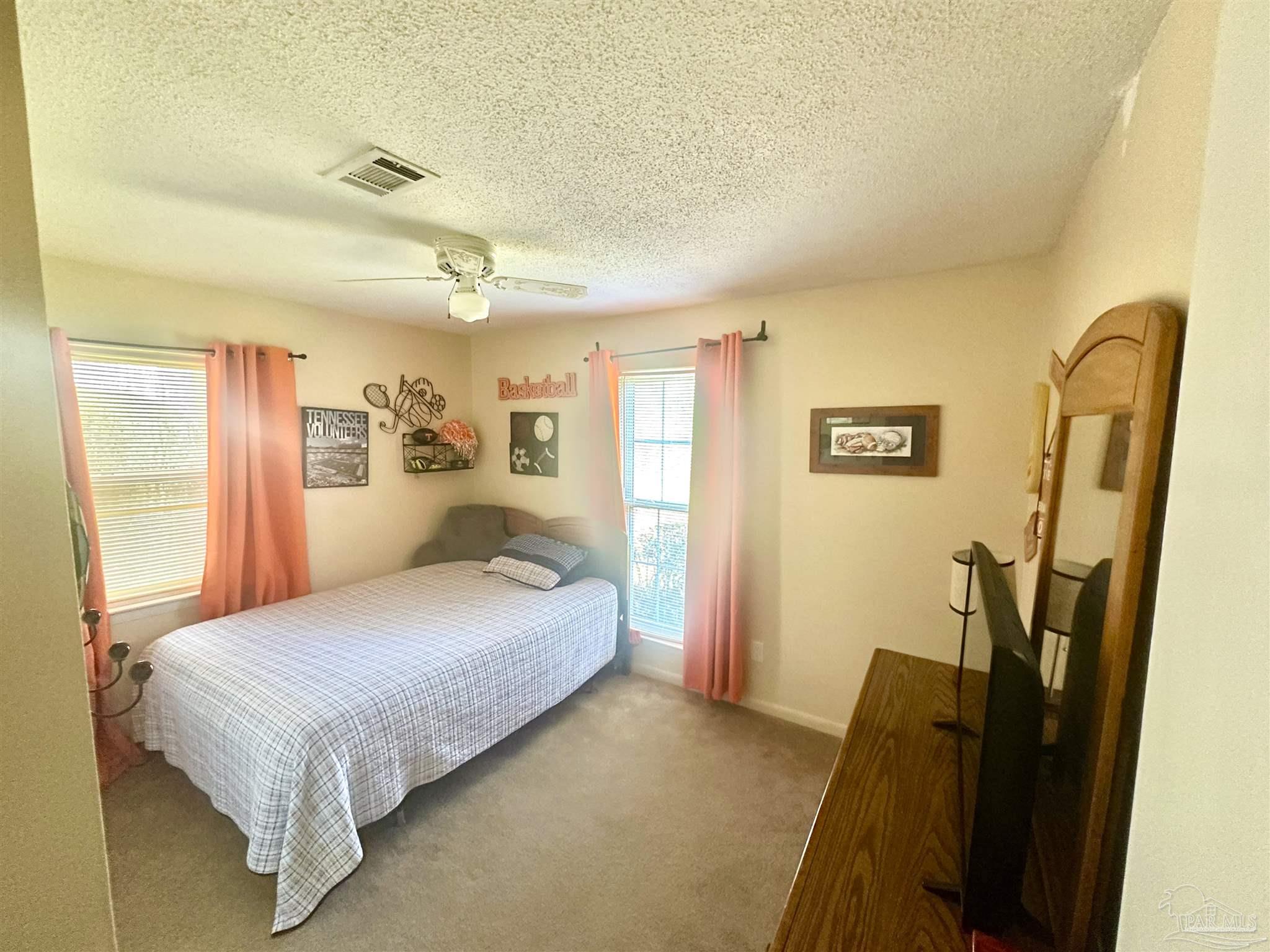 5057 Babb Lane Pace, FL 32571 - Photo 21 of 33 a bedroom with a bed dresser and a window