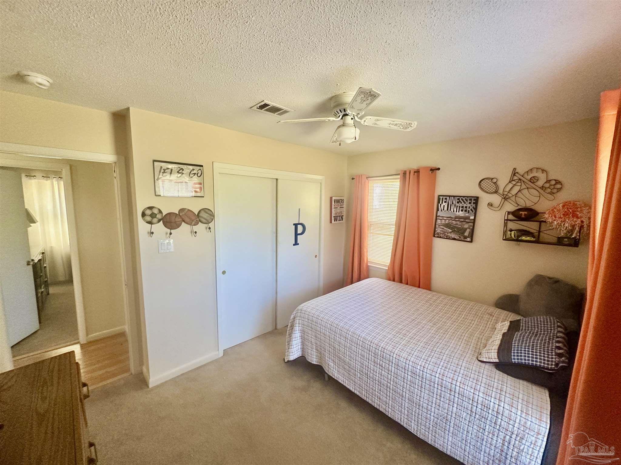 5057 Babb Lane Pace, FL 32571 - Photo 22 of 33 a bedroom with a bed and a mirror