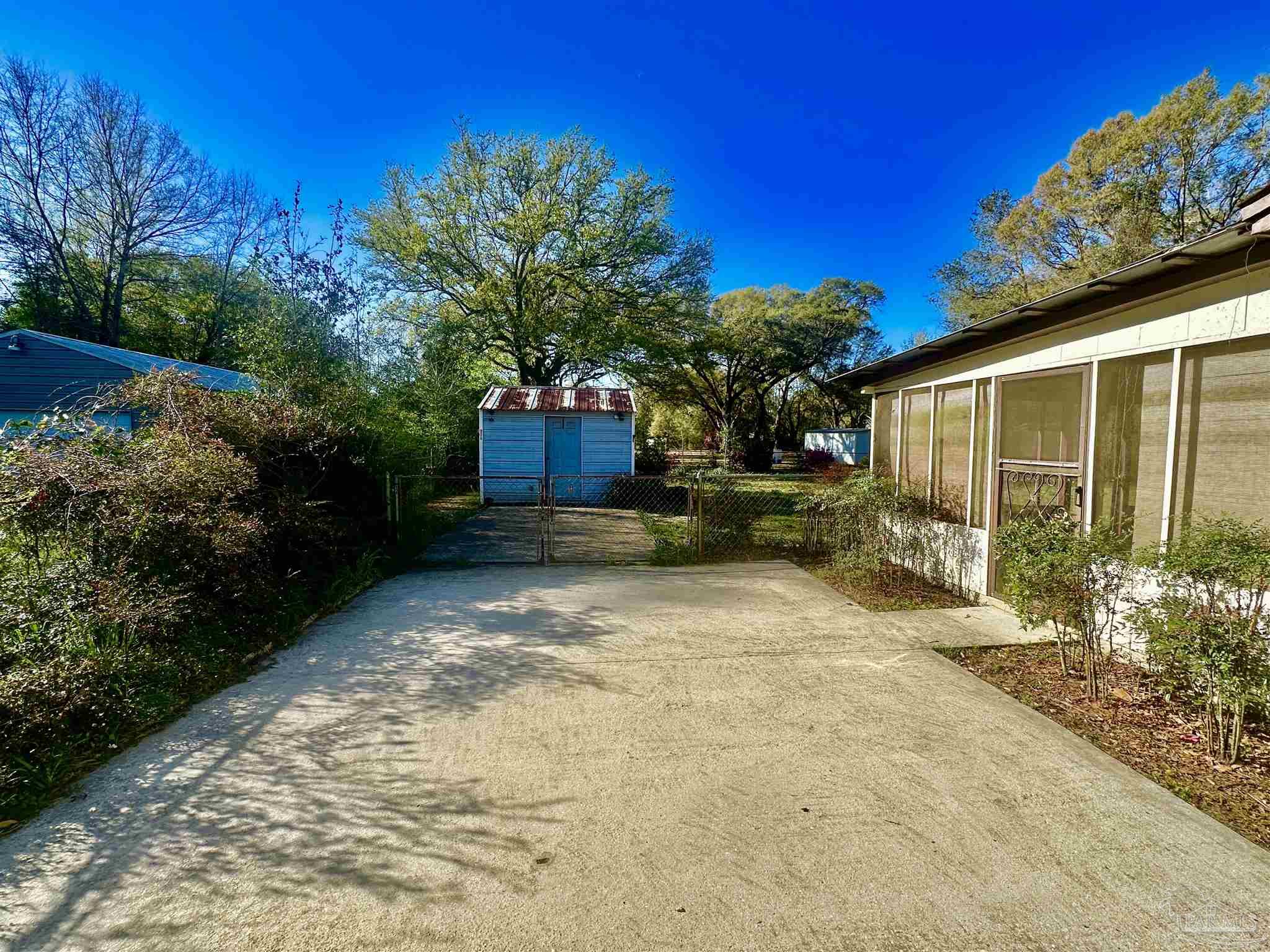 5057 Babb Lane Pace, FL 32571 - Photo 32 of 33 a view of a backyard with potted plants and large tree