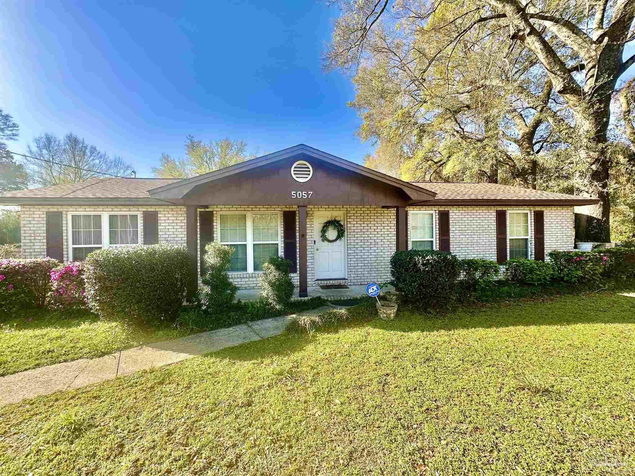 5057 Babb Lane Pace, FL 32571 - Photo 4 of 33 a front view of a house with garden and patio