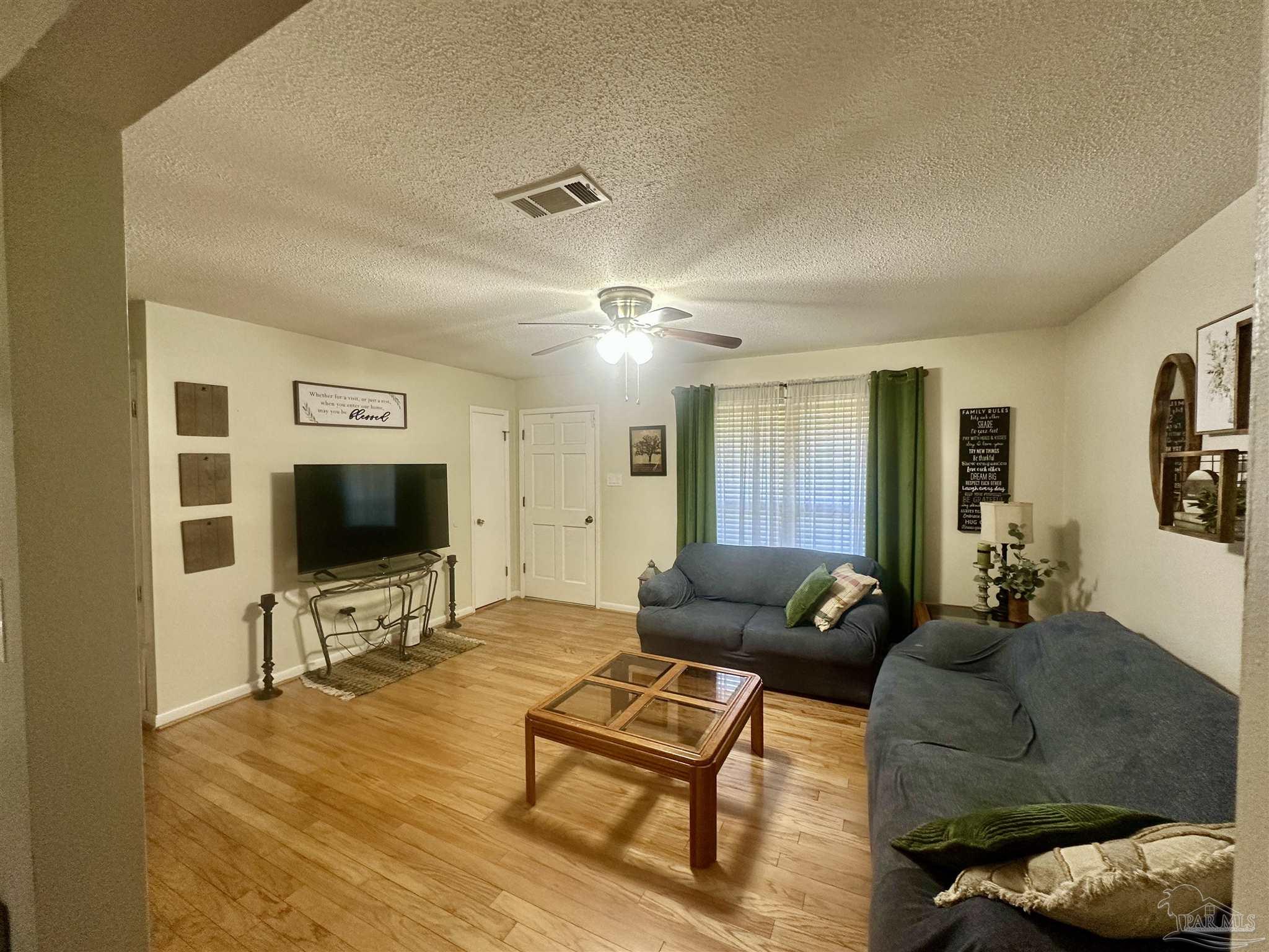 5057 Babb Lane Pace, FL 32571 - Photo 8 of 33 a living room with furniture and a flat screen tv
