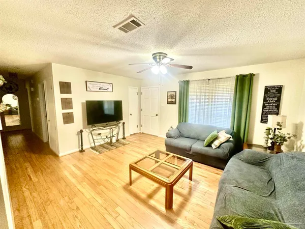 a living room with furniture and a flat screen tv