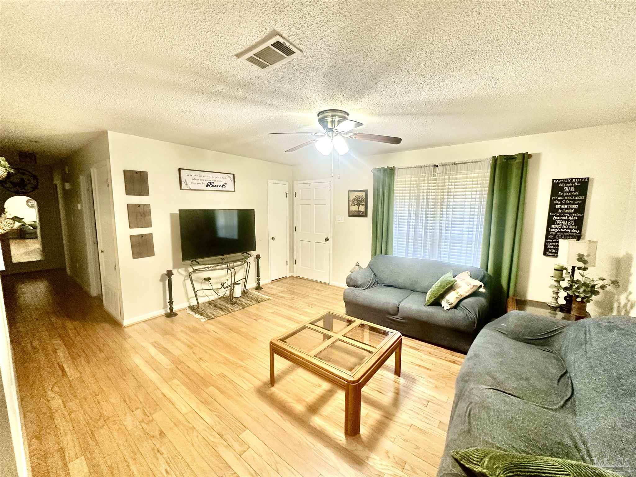 5057 Babb Lane Pace, FL 32571 - Photo 9 of 33 a living room with furniture and a flat screen tv