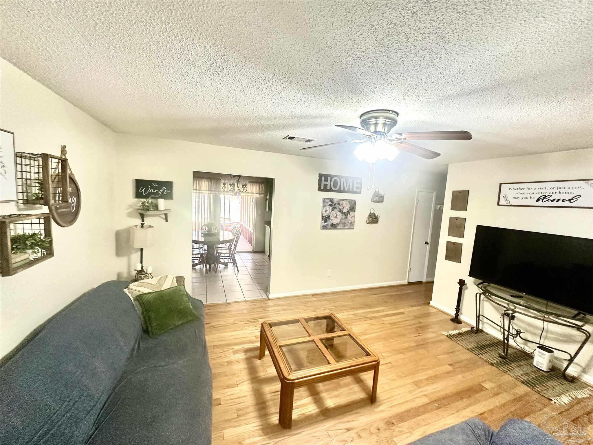 5057 Babb Lane Pace, FL 32571 - Photo 10 of 33 a living room with furniture and a flat screen tv
