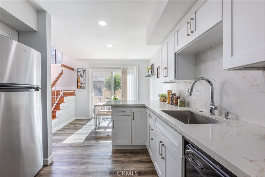 12635 Briarglen Loop, Unit H Stanton, CA 90680 - Photo 18 of 43 a kitchen with white cabinets and sink