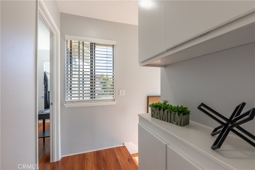 12635 Briarglen Loop, Unit H Stanton, CA 90680 - Photo 21 of 43 a hallway with a chair and a potted plant