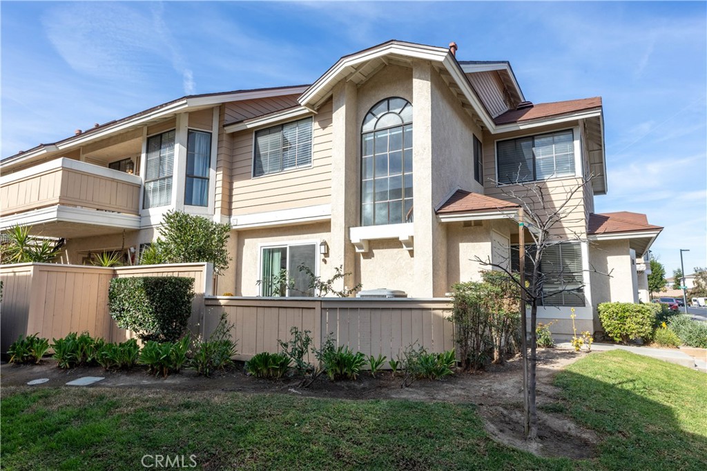 12635 Briarglen Loop, Unit H Stanton, CA 90680 - Photo 36 of 43 a front view of a house with garden