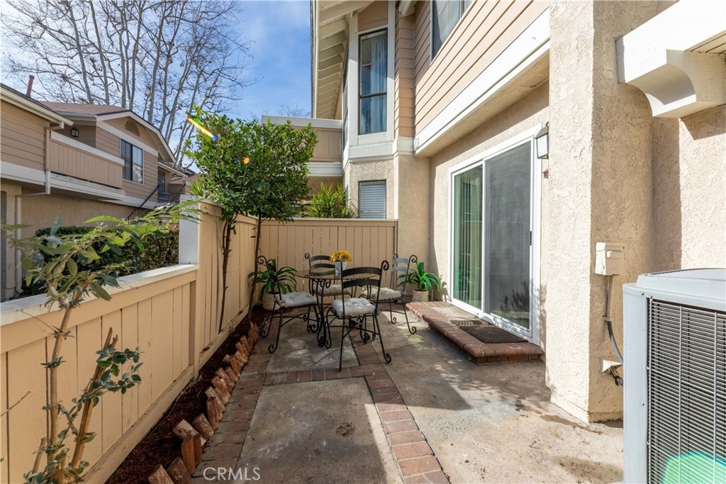 12635 Briarglen Loop, Unit H Stanton, CA 90680 - Photo 37 of 43 a view of a patio with table and chairs and potted plants