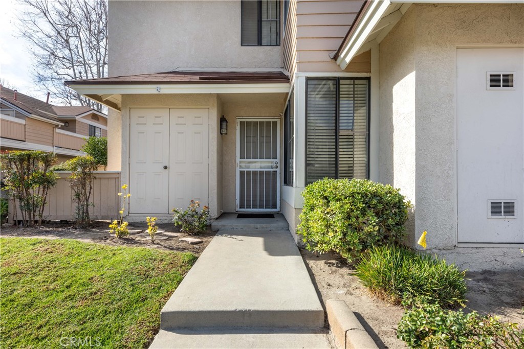 12635 Briarglen Loop, Unit H Stanton, CA 90680 - Photo 4 of 43 a front view of a house with garden