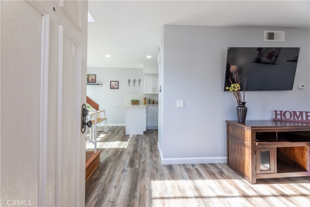 12635 Briarglen Loop, Unit H Stanton, CA 90680 - Photo 5 of 43 a living room with furniture and a flat screen tv