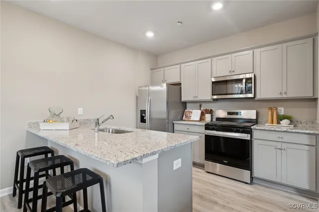 a kitchen with a stove a sink and a refrigerator
