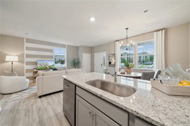 a kitchen with a sink and living room