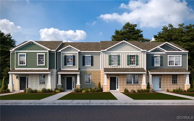 a front view of a house with yard and trees