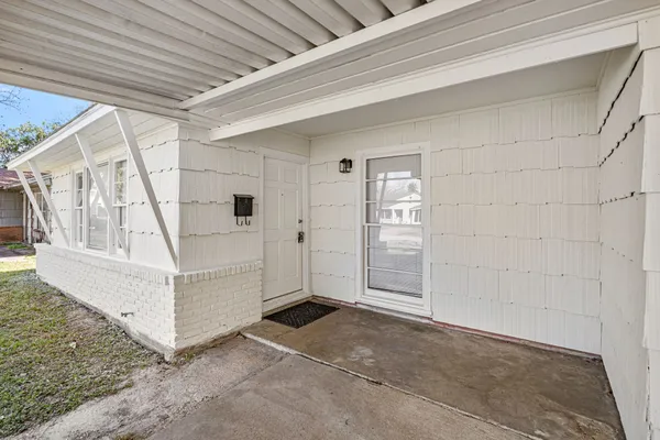 a view of an empty room with windows