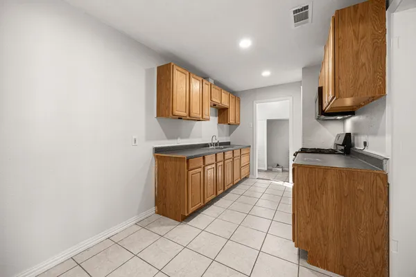 a kitchen with stainless steel appliances granite countertop a sink and cabinets