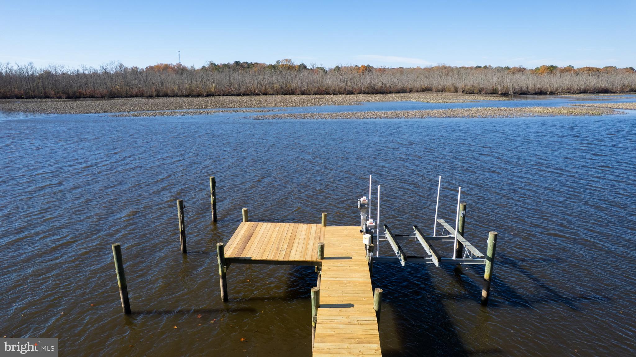 25211 Adams Landing Road Denton, MD 21629 - Photo 21 of 58 a view of a balcony with wooden floor and lake view