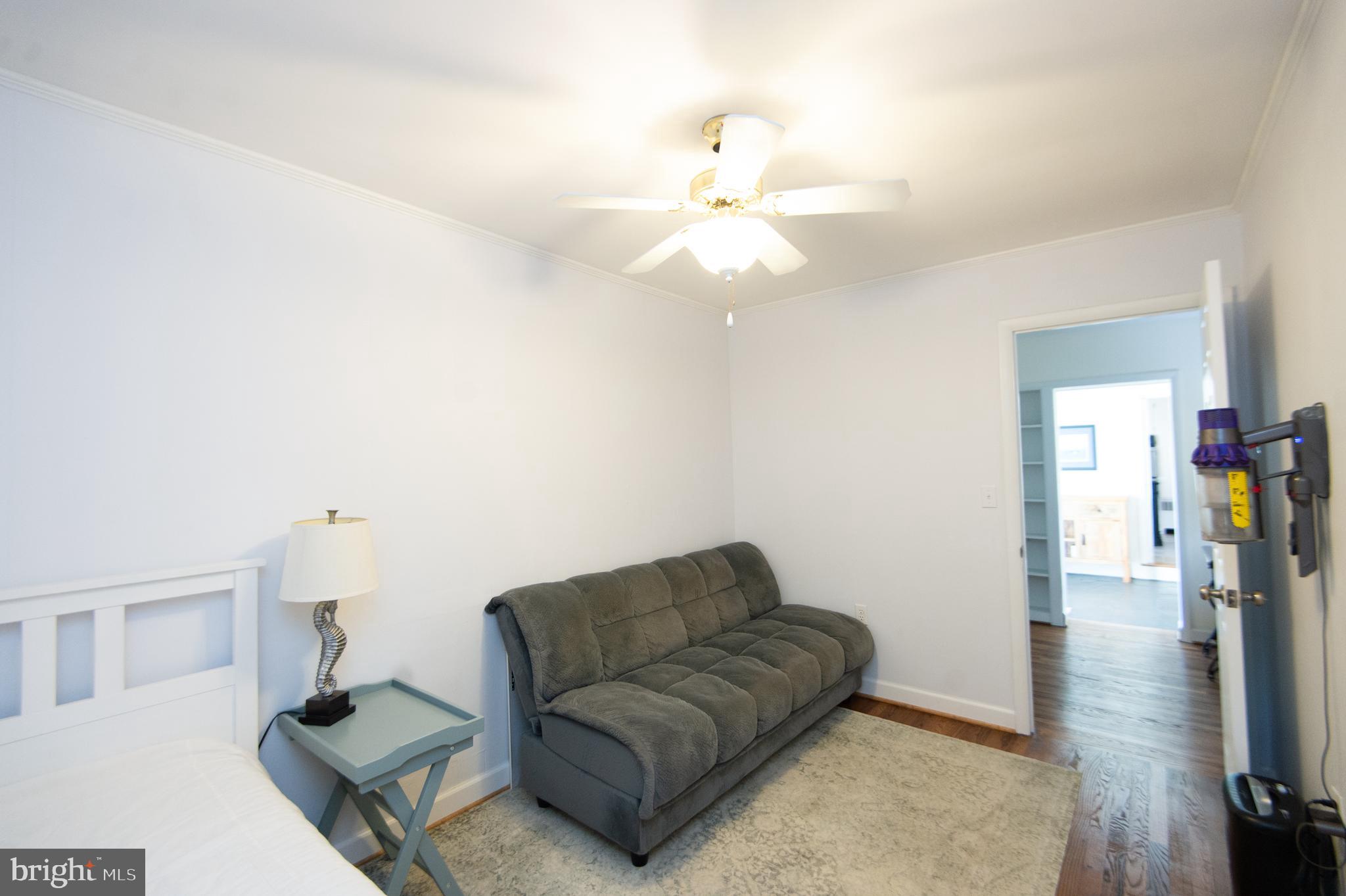 25211 Adams Landing Road Denton, MD 21629 - Photo 23 of 58 a living room with furniture and a chandelier