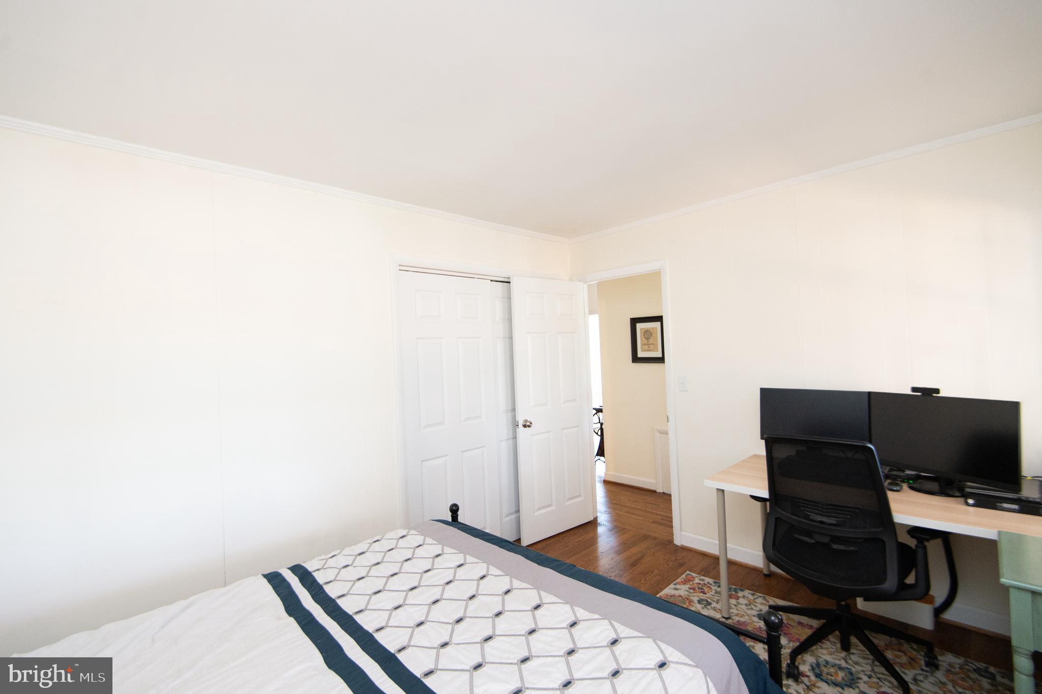 25211 Adams Landing Road Denton, MD 21629 - Photo 30 of 58 a bedroom with a bed and a computer on a desk next to a window