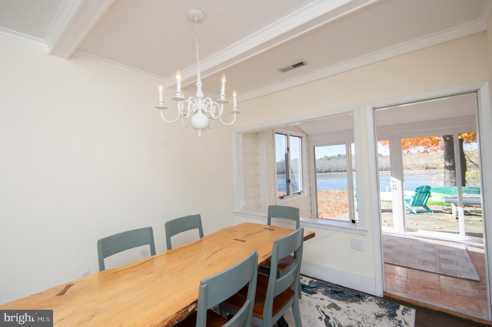 25211 Adams Landing Road Denton, MD 21629 - Photo 32 of 58 a view of a dining room with furniture wooden floor and chandelier