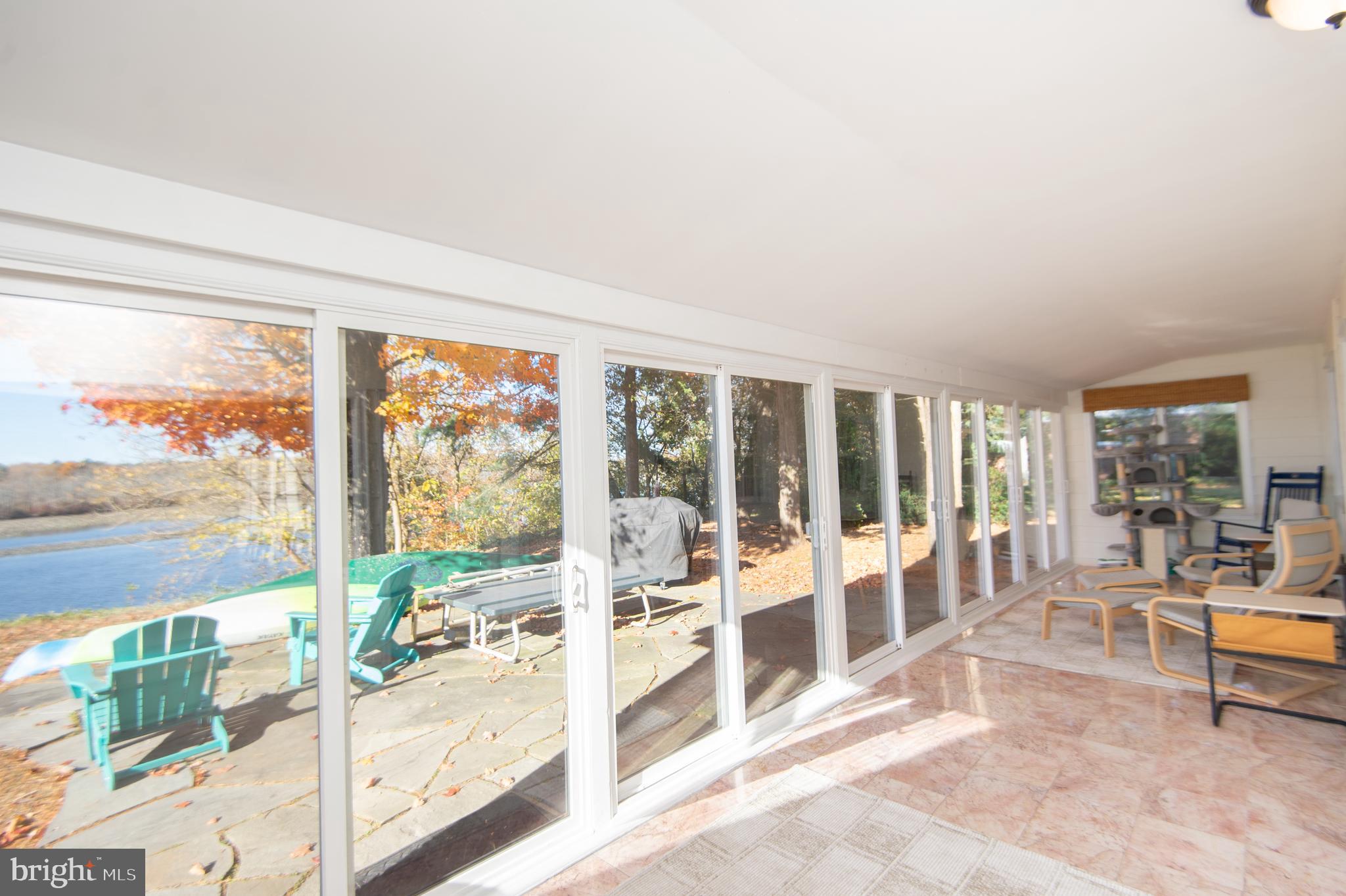 25211 Adams Landing Road Denton, MD 21629 - Photo 33 of 58 a living room with a large window and a table