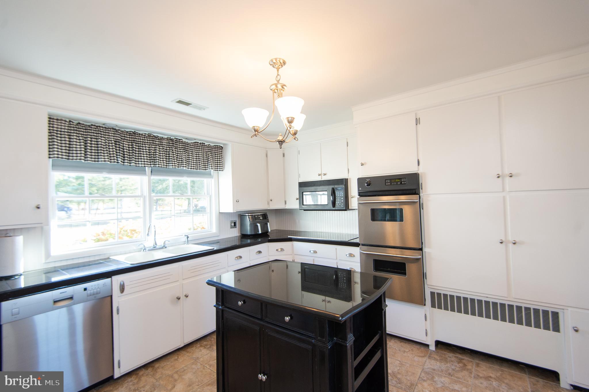 25211 Adams Landing Road Denton, MD 21629 - Photo 35 of 58 a kitchen that has a sink a microwave and window