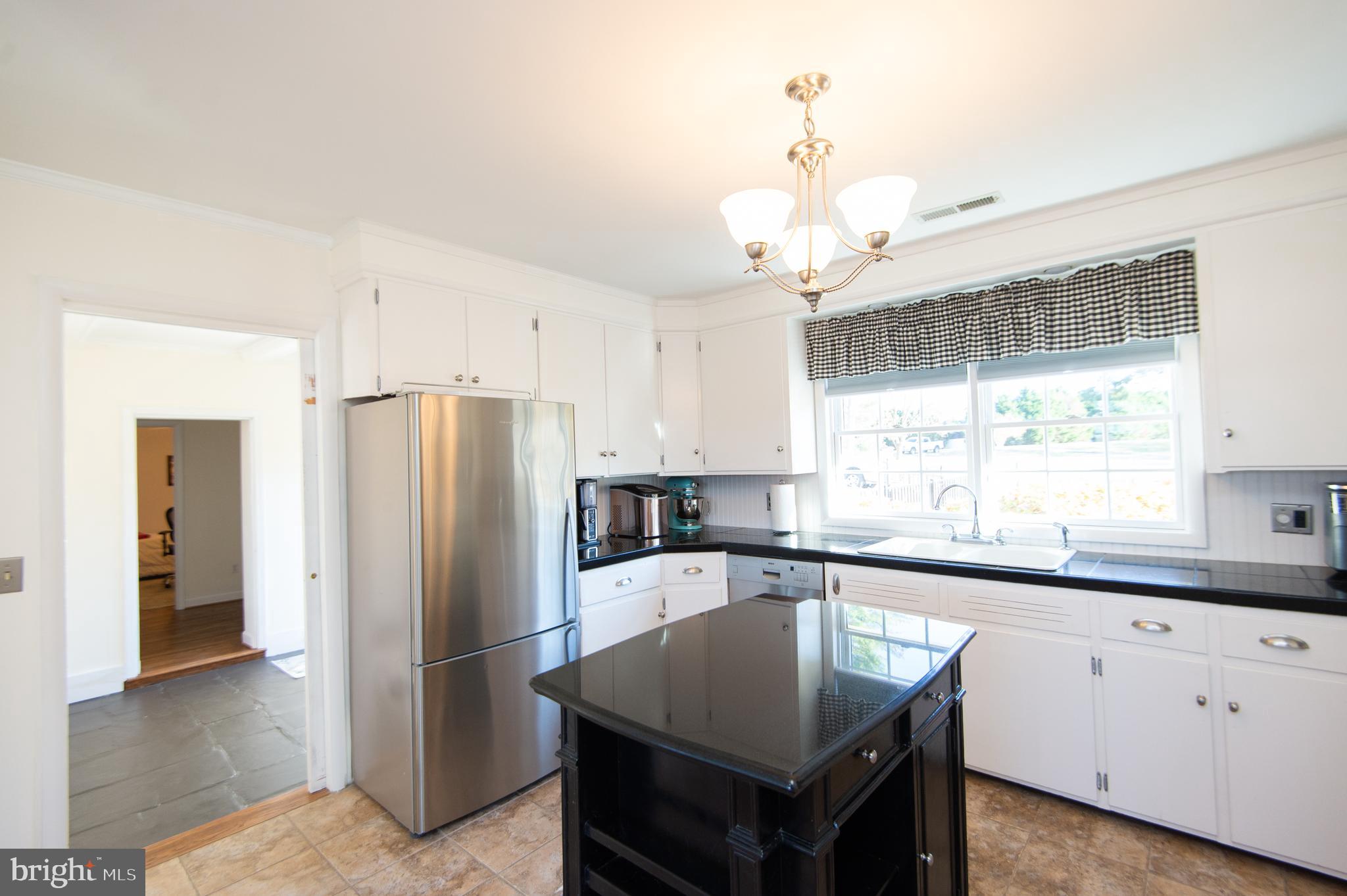 25211 Adams Landing Road Denton, MD 21629 - Photo 36 of 58 a kitchen with stainless steel appliances granite countertop a sink a refrigerator and a granite counter tops