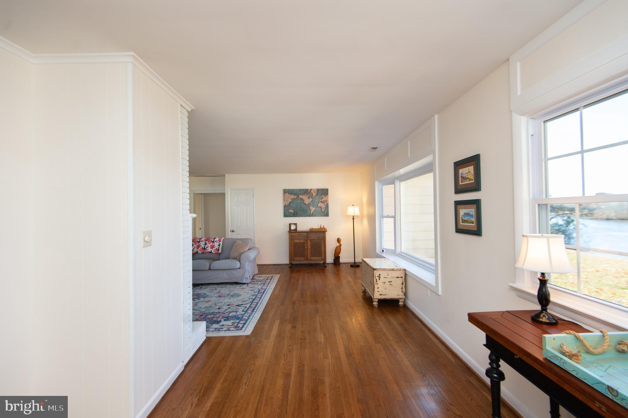 25211 Adams Landing Road Denton, MD 21629 - Photo 39 of 58 a living room with furniture and a wooden floor