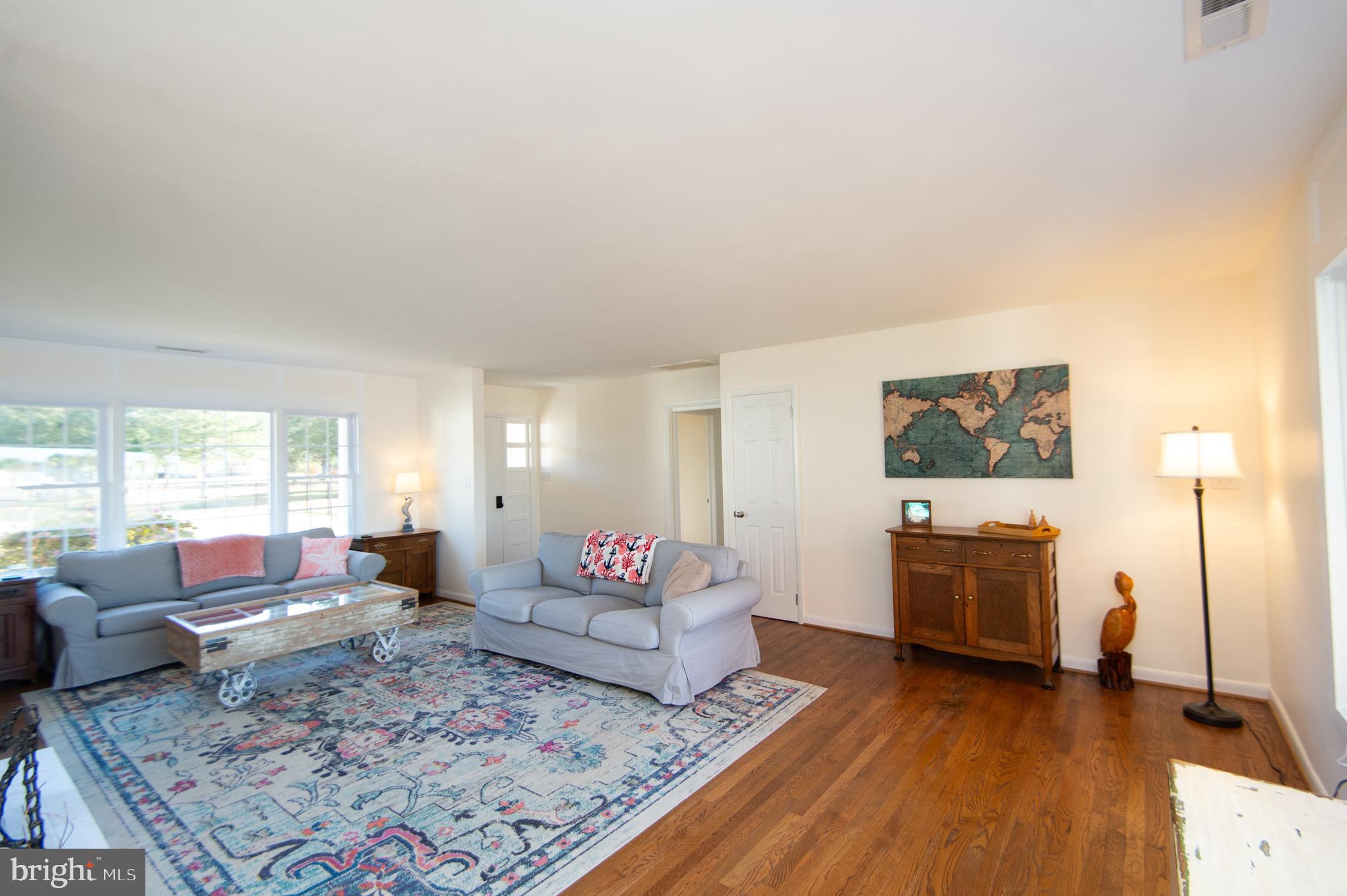 25211 Adams Landing Road Denton, MD 21629 - Photo 41 of 58 a living room with furniture and a wooden floor