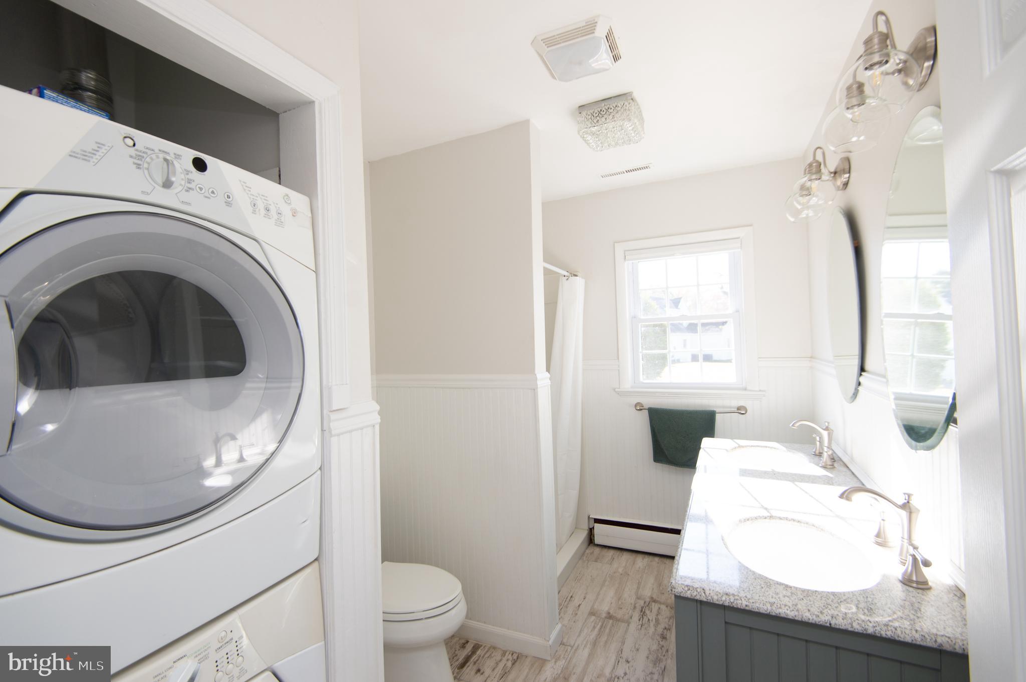 25211 Adams Landing Road Denton, MD 21629 - Photo 52 of 58 a living room with a washer and dryer
